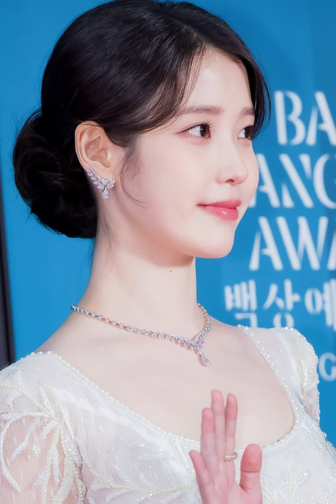 IU richest K-pop idol 2025, IU net worth, Korean soloist actress IU at fashion event
