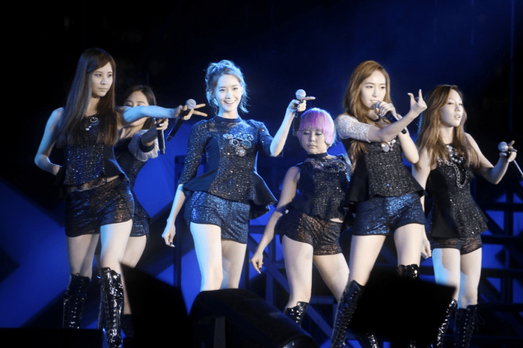 Second generation K-pop leaders Girls' Generation in a classic group formation, representing the Hallyu Wave's global expansion.