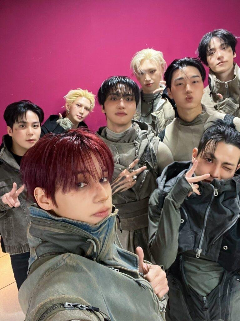 ATEEZ NASA B-side promotional photo showing space-themed styling with metallic silver and black stage costumes