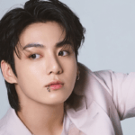Jungkook posing in a high-quality editorial photoshoot with soft lighting