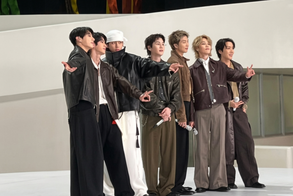 Screenshots comparing “Arirang” digital credits where Jin appears missing on one platform