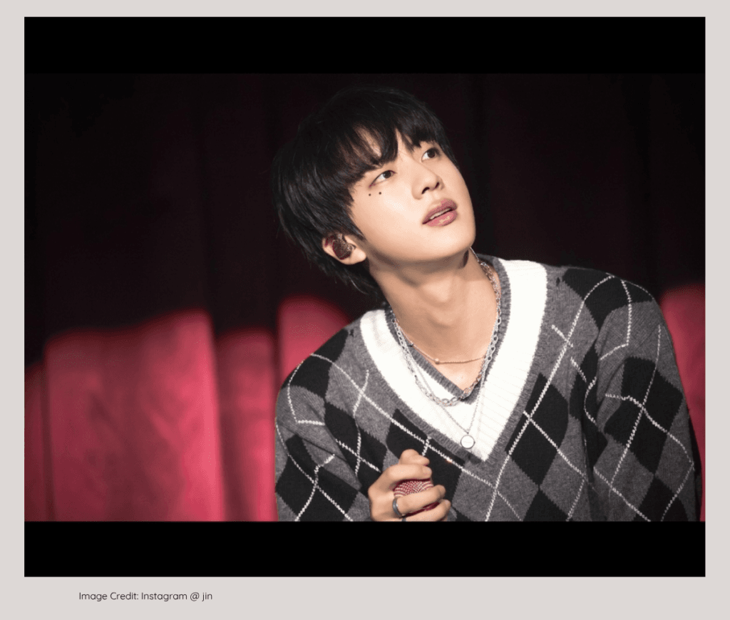 BTS Jin smiling warmly, born to a wealthy, successful CEO father.